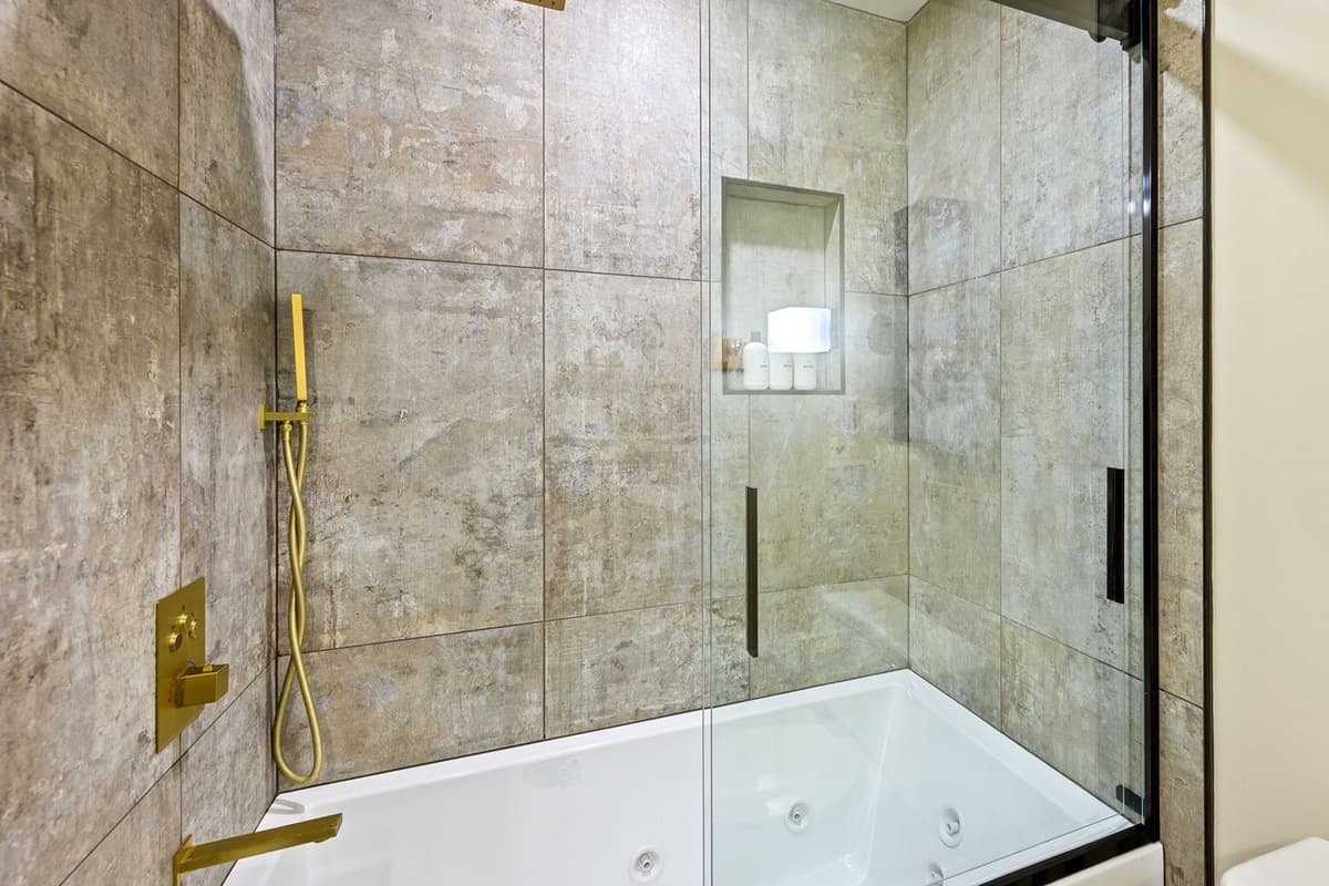 The full bathroom features a convenient shower and tub combination.