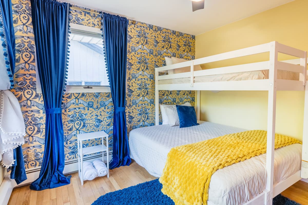 This inviting bedroom features a twin-over-queen bunk bed, offering comfortable sleeping arrangements for up to three guests.