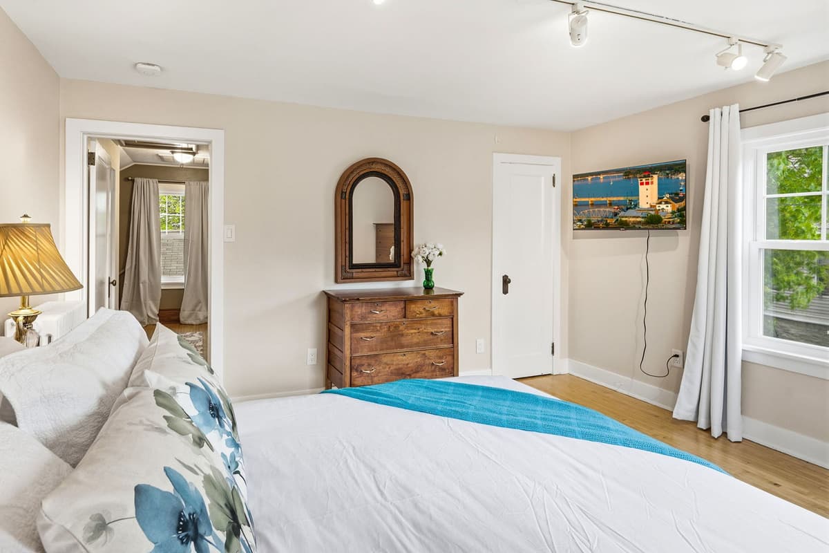 The second upstairs bedroom features a comfortable queen-size bed, offering a cozy and private space to relax and recharge.