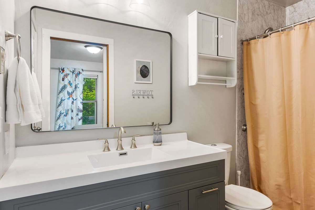 Freshen up with ease in the convenient full bathroom, thoughtfully located near the bedrooms.