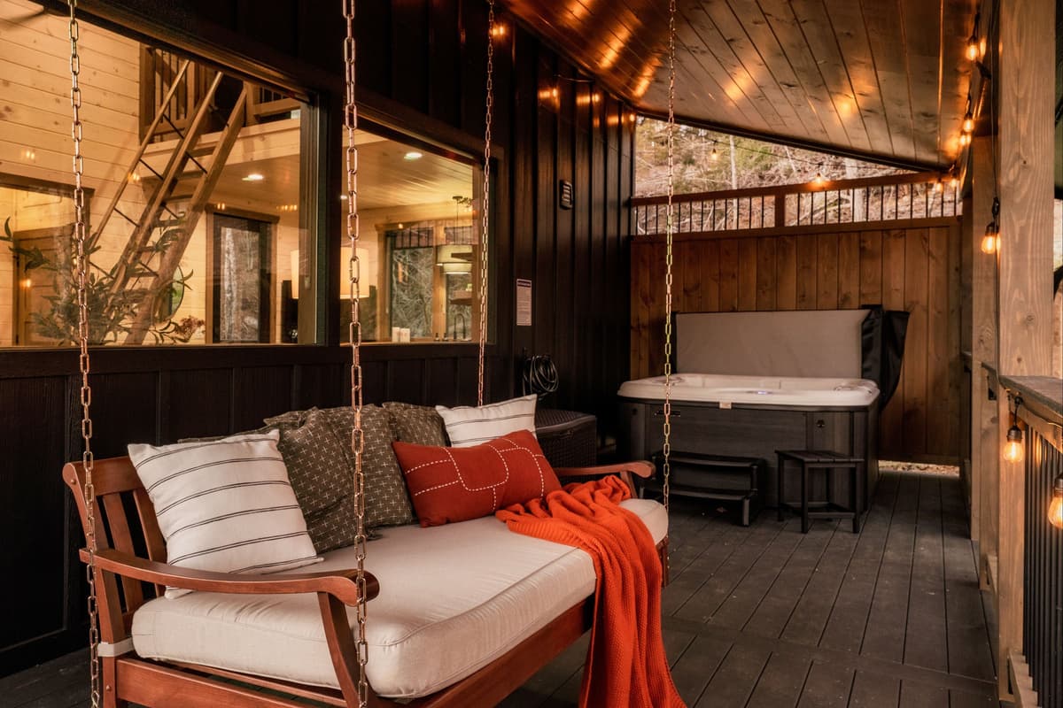 Step outside to enjoy your own relaxing outdoor retreat, featuring a comfortable porch swing and private hot tub.