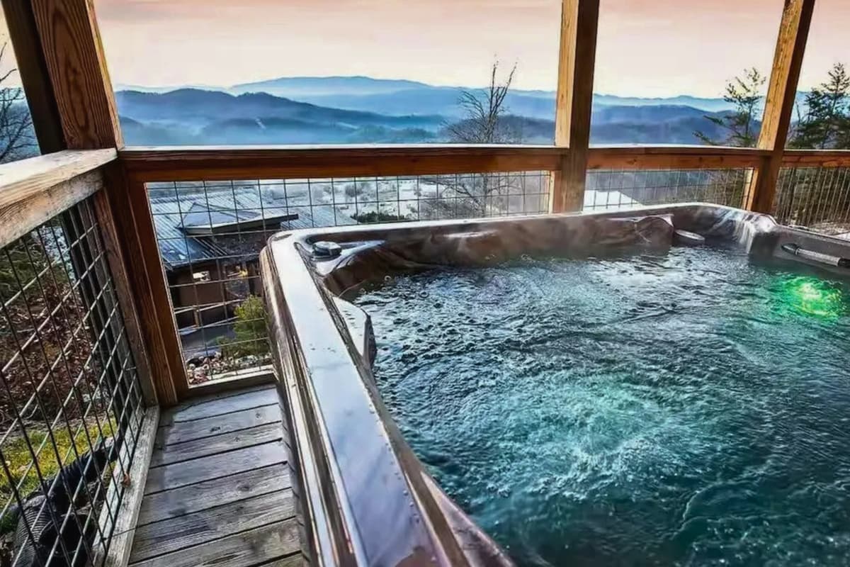 The outdoor hot tub offers the perfect spot to unwind while enjoying the beautiful mountain scenery.