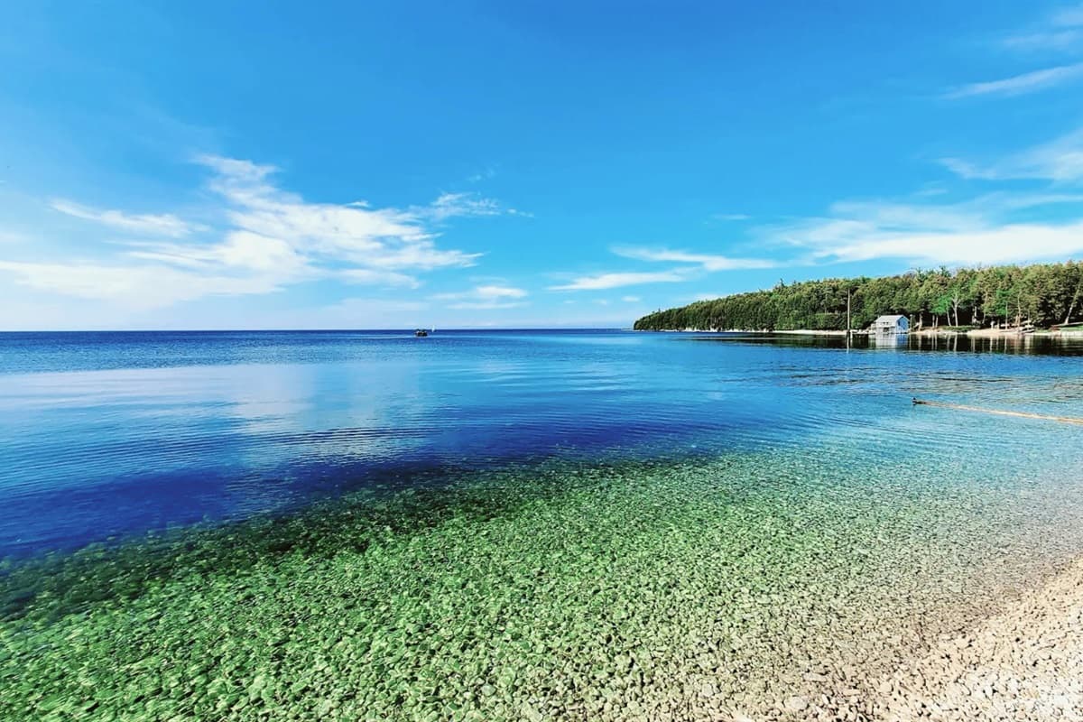 Stroll along Pebble Beach, where smooth stones, tranquil waters, and breathtaking views create a peaceful escape in Door County!
