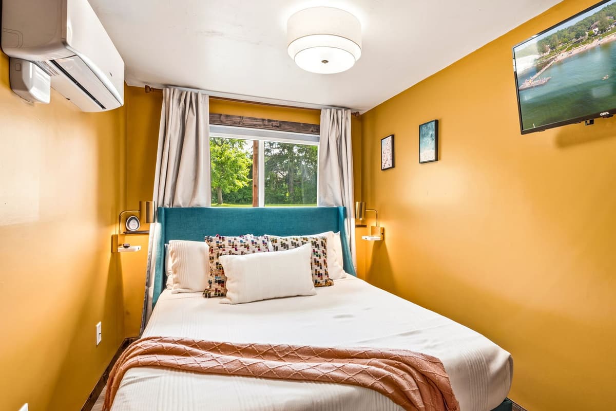 The Yellow Room features a comfortable queen-size bed in a bright and cheerful space. Its warm yellow tones create a welcoming atmosphere for relaxing after a day of adventure.