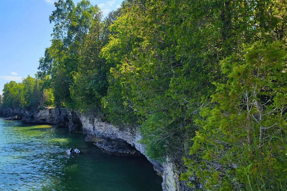 Explore the natural wonders of Cave Point County Park, where dramatic cliffs and crystal-clear waters offer breathtaking views and endless adventure!