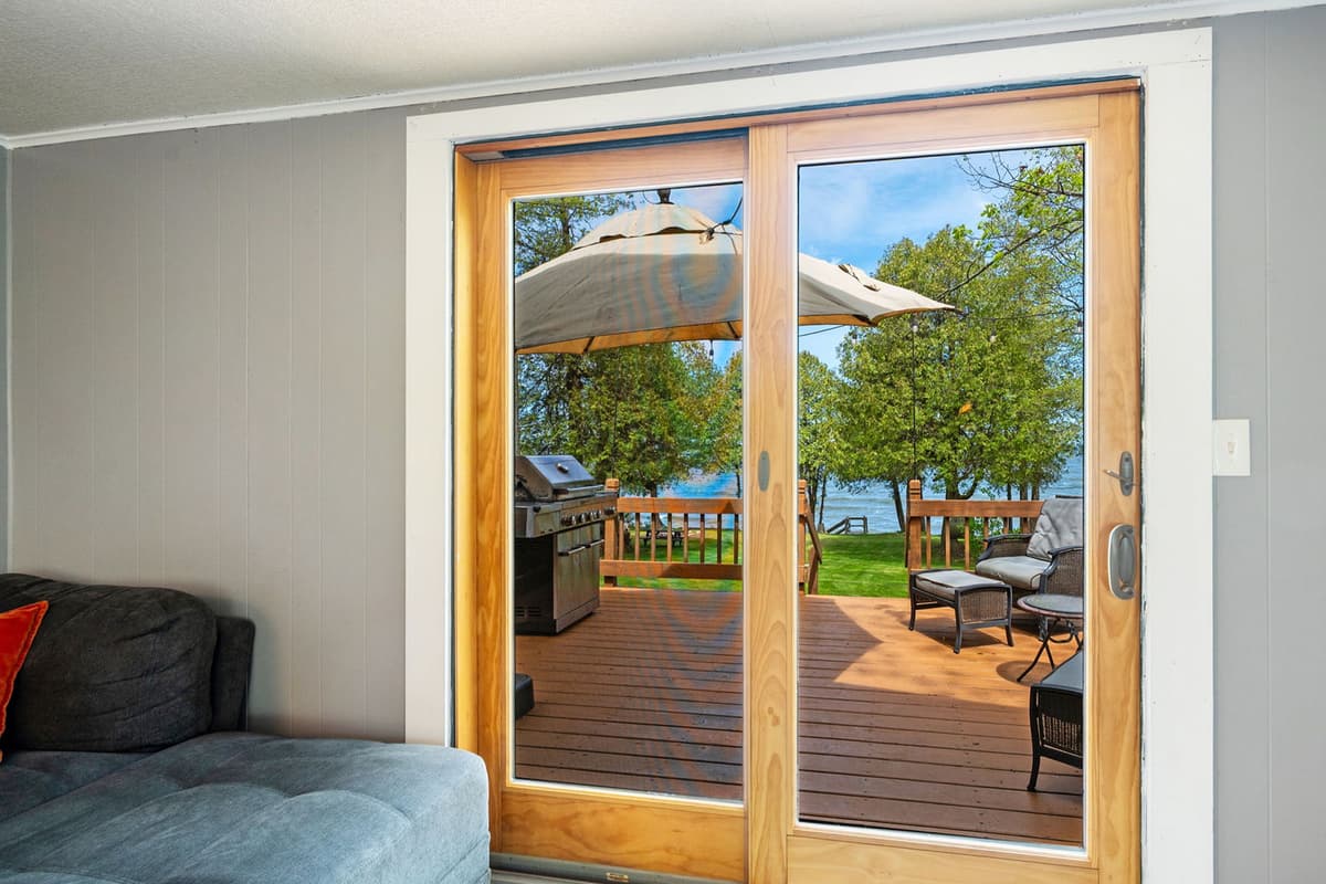 Large doors provide a connection to the outdoor area, bringing in natural light and making the space feel open and welcoming.