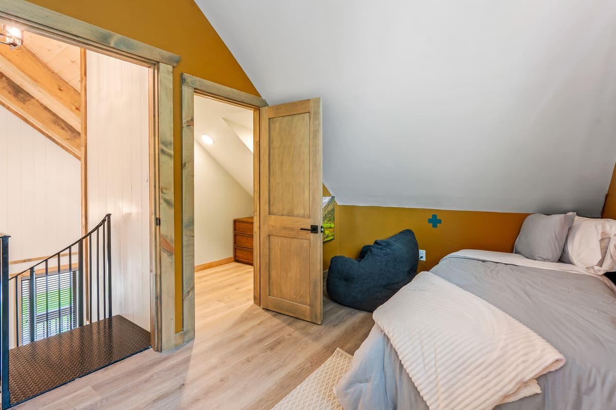 Upstairs, you’ll find a cozy bedroom designed with families and groups in mind.