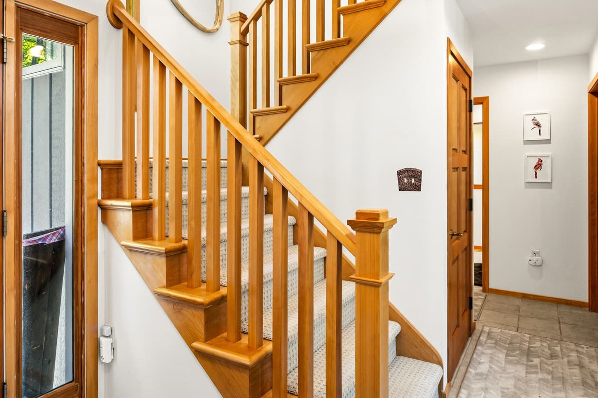 The staircase provides easy access from the main level to the upstairs bedrooms and living spaces.