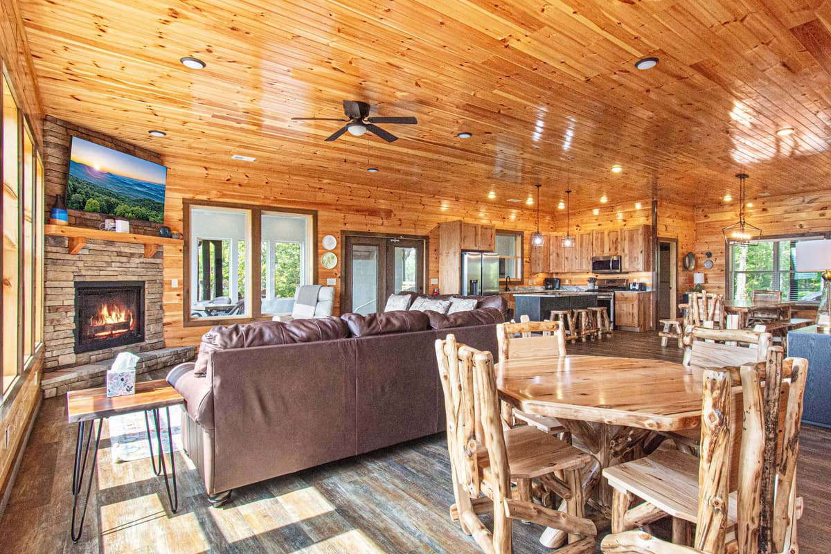 The living room flows seamlessly into the dining area and fully equipped kitchen, creating a warm and inviting space for relaxing, dining, and spending quality time with family and friends.
