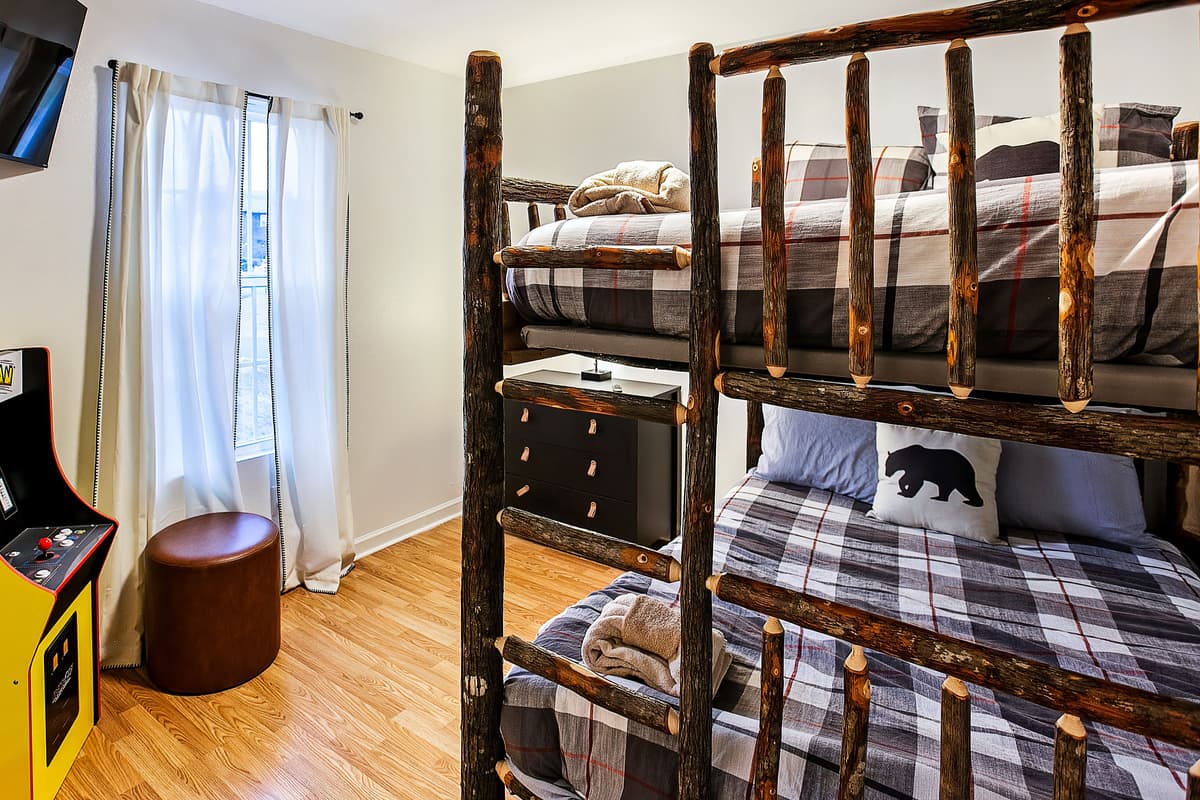 The bunk bedroom features a queen-over-queen bunk bed for comfortable sleeping space.