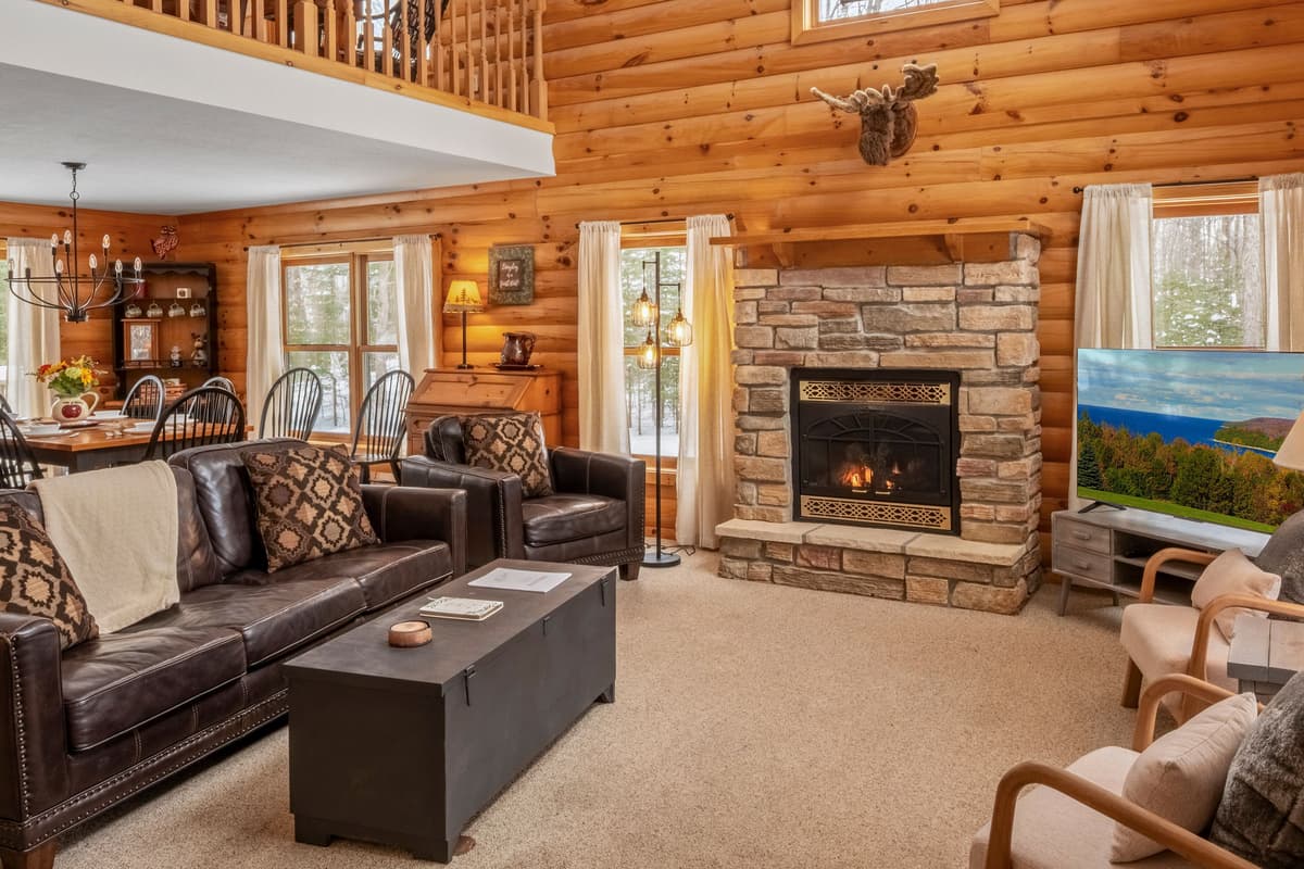 Relax in the inviting living room, featuring large windows that fill the space with natural light and offer a lovely view of the surrounding area.