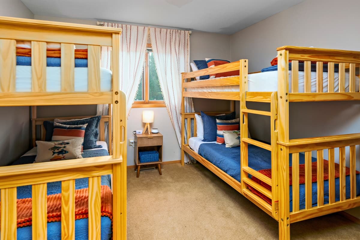 This room features two twin-over-twin bunk beds, perfect for kids or groups.