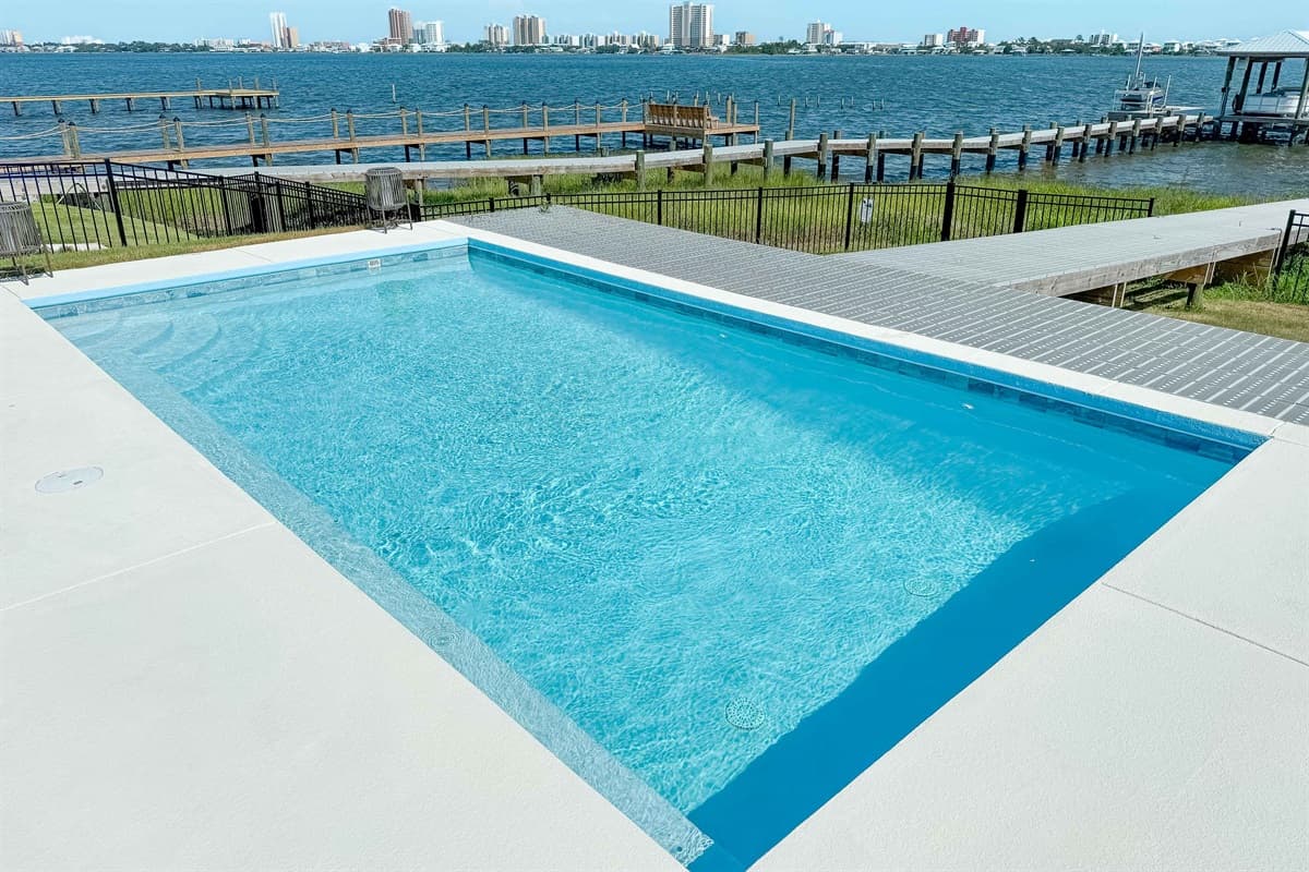 This inviting private pool is surrounded by a spacious patio, offering stunning views of the serene bay and private docks.