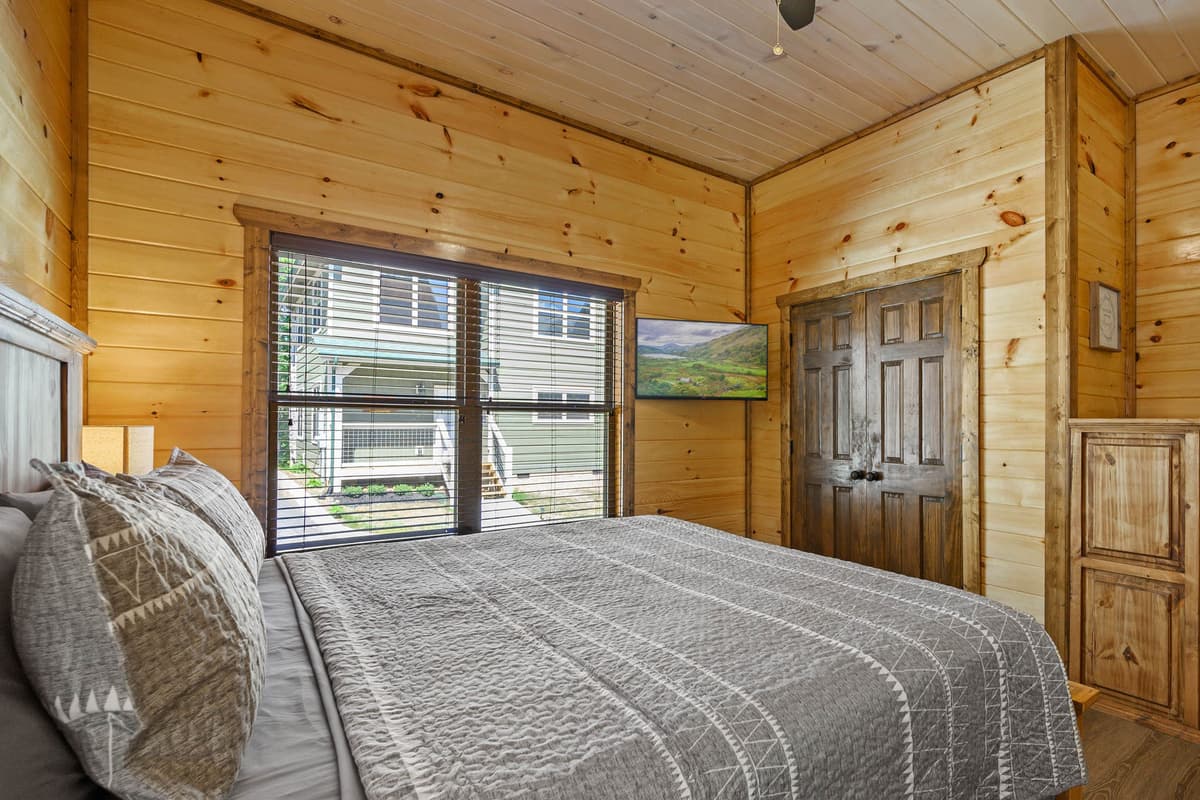 The comfortable queen bed offers a welcoming place to rest and recharge. Its convenient main-level location makes it easy to access without navigating stairs.