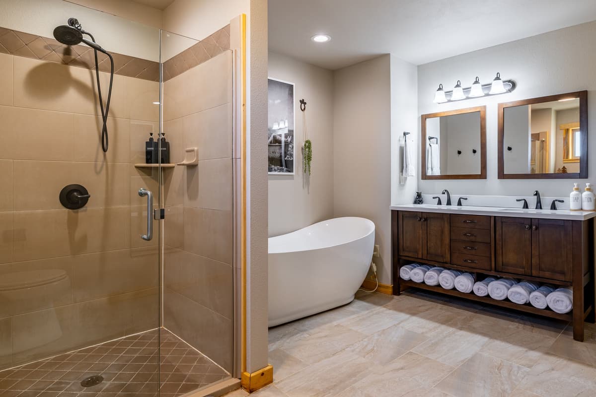 Refresh and unwind in the cabin’s full bathroom, featuring a spacious walk-in shower and a relaxing bathtub.