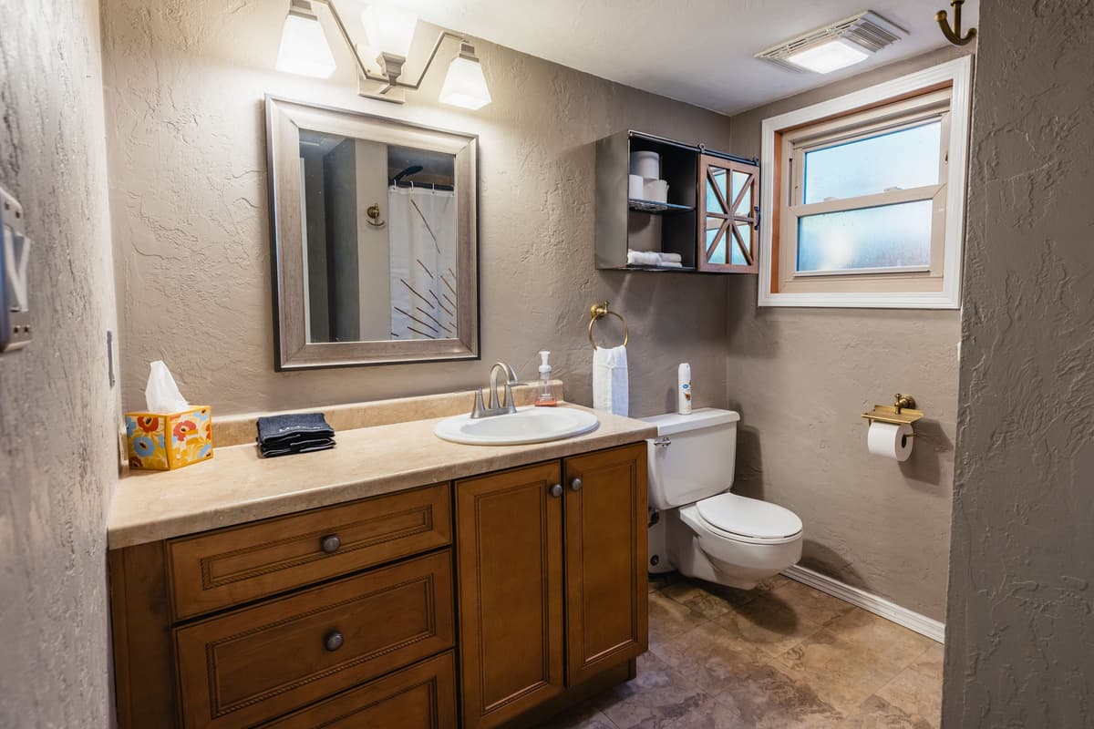 The upstairs bathroom offers a clean and convenient space for guests.