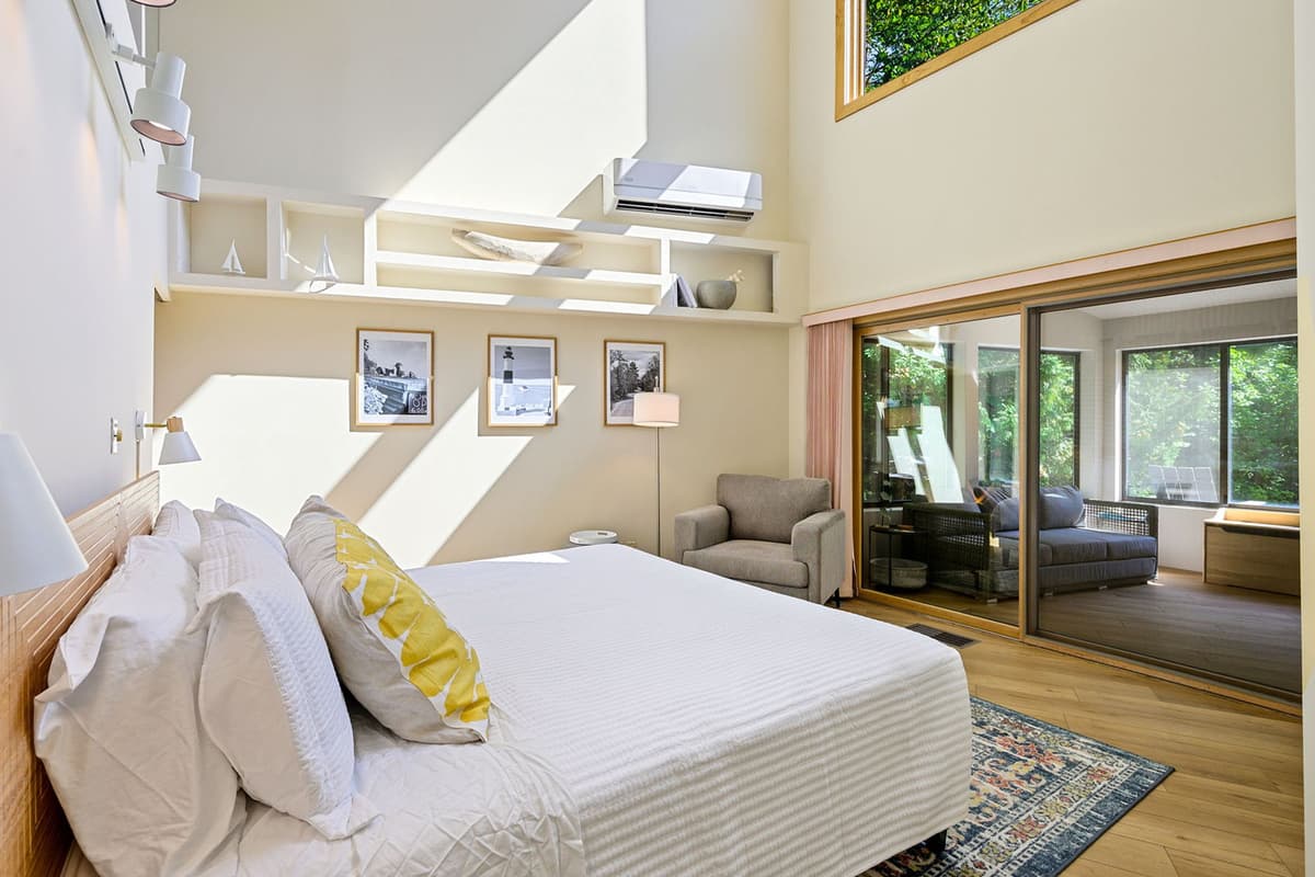 A glass door provides a stylish separation for the comfortable king bedroom.