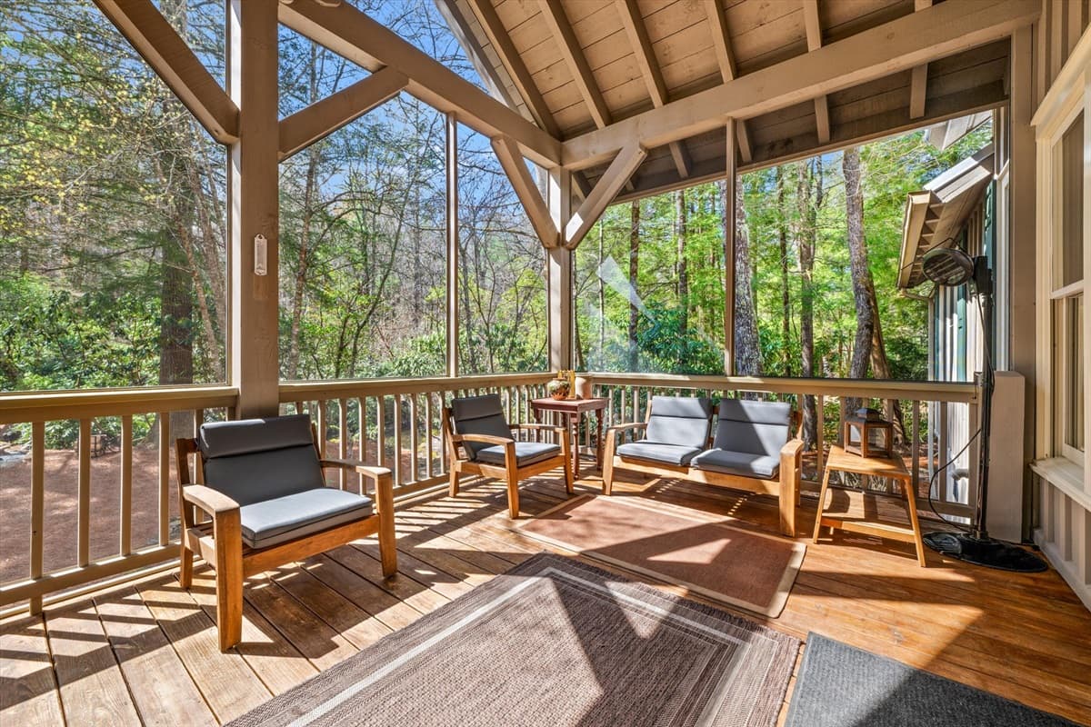 Spacious Covered Porch with Comfortable Outdoor Seating and Wooded Views