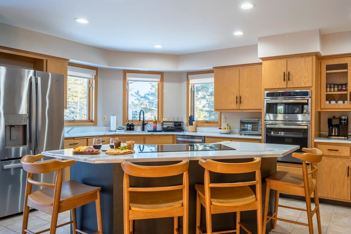 The kitchen features sleek stainless steel appliances and is fully stocked with everything you need for cooking.
