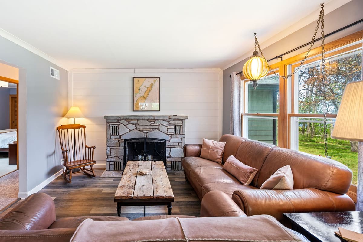 Relax in the inviting living room, featuring comfortable seating and a cozy fireplace.
