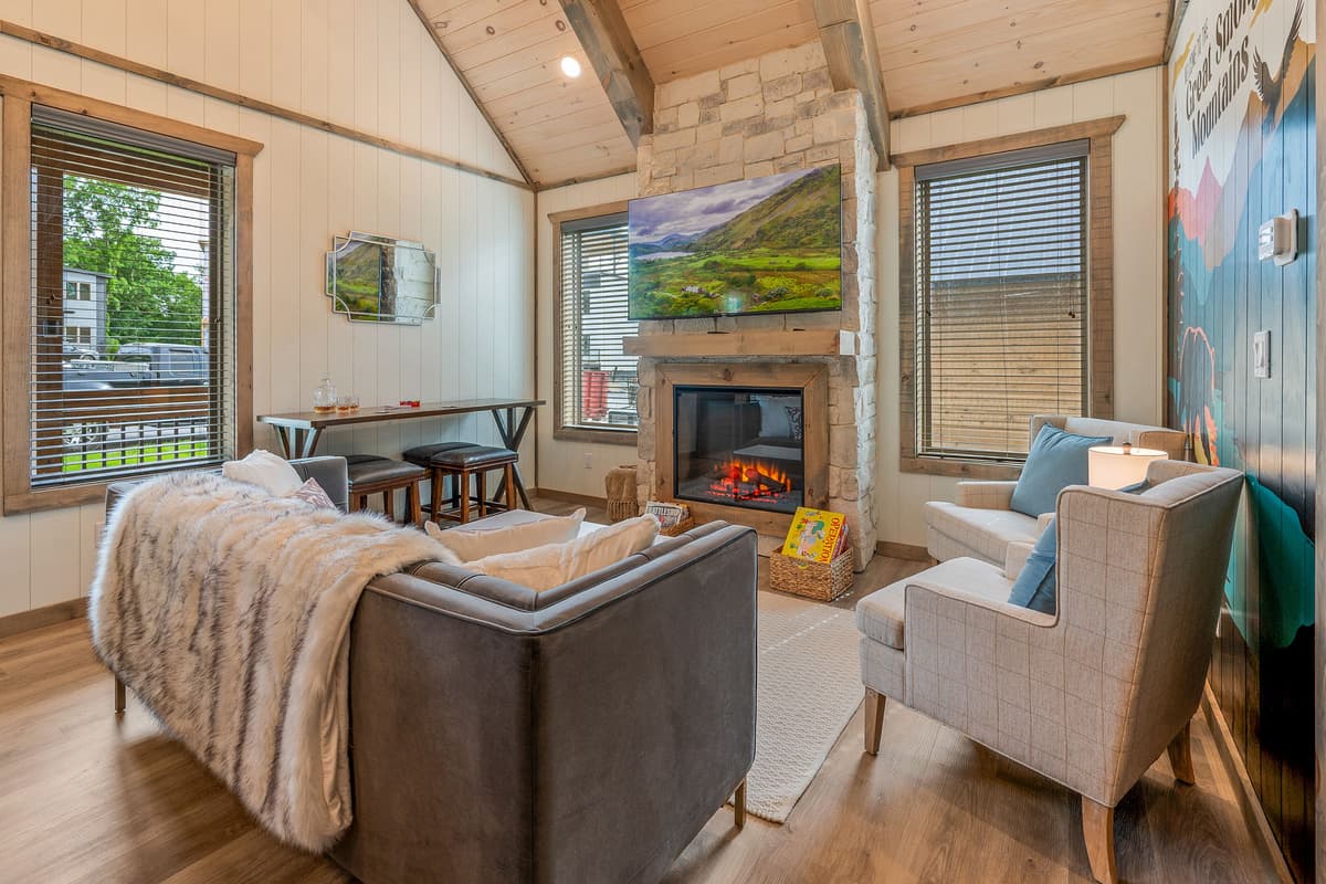 Sink into the comfortable seating, turn on the TV, and gather around the fireplace as the cabin settles into a warm, relaxing atmosphere.