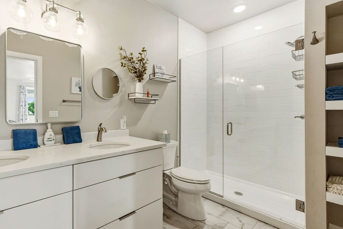 This clean and comfortable bathroom features a spacious walk-in shower for easy and convenient use.