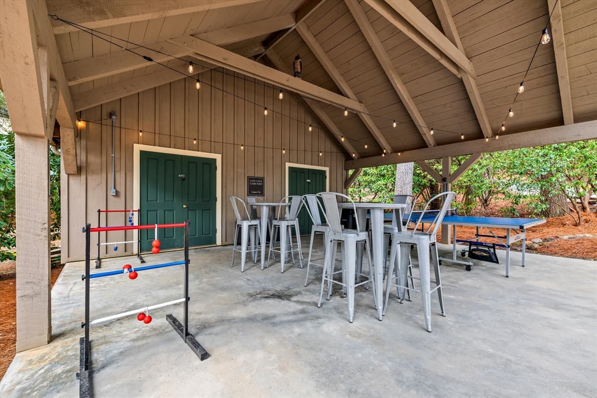 Outdoor Game Area with Hillbilly Golf, Ping Pong Table, Outdoor Jenga, Bar Seating and String Lights