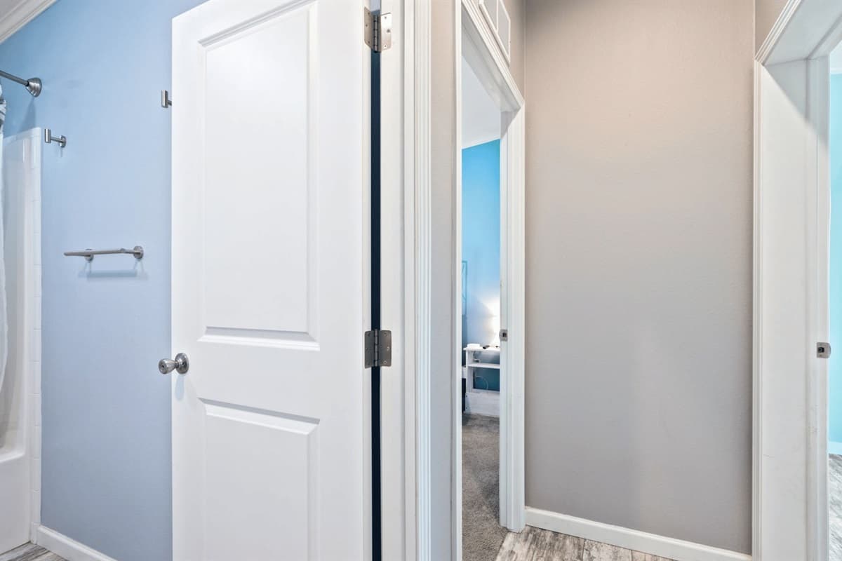 Discover the gateway to comfort! Our beautifully designed doors lead you to a peaceful bedroom and a serene bathroom—your perfect retreat.