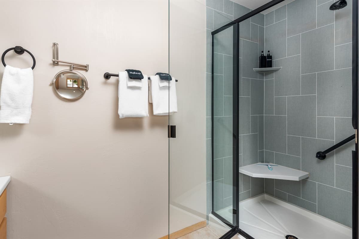 Enjoy a refreshing retreat in this sleek, modern bathroom with a spacious shower and all the essentials for a relaxing stay.