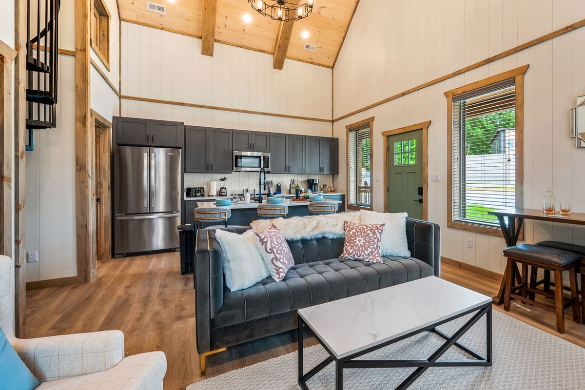 The spacious open-concept living area is the heart of the cabin, bringing the living, dining, and kitchen spaces together in one inviting setting.