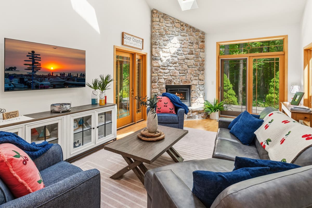 The living area offers a comfortable spot to unwind, watch TV, or gather around the fireplace.
