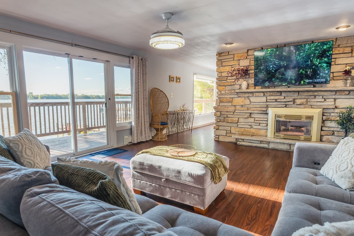 Relax in the spacious and inviting living area, where large sliding glass doors bring in plenty of natural light and showcase beautiful views of the lake.