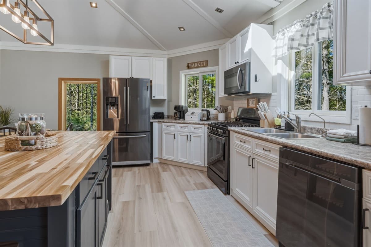 Featuring stainless steel appliances for a clean, modern touch and reliable everyday use, the space is both stylish and functional.