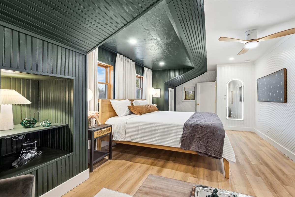 Across is another bedroom, the spacious king-sized bed is dressed in soft, high-thread-count linens, creating the perfect spot to unwind after a long day.