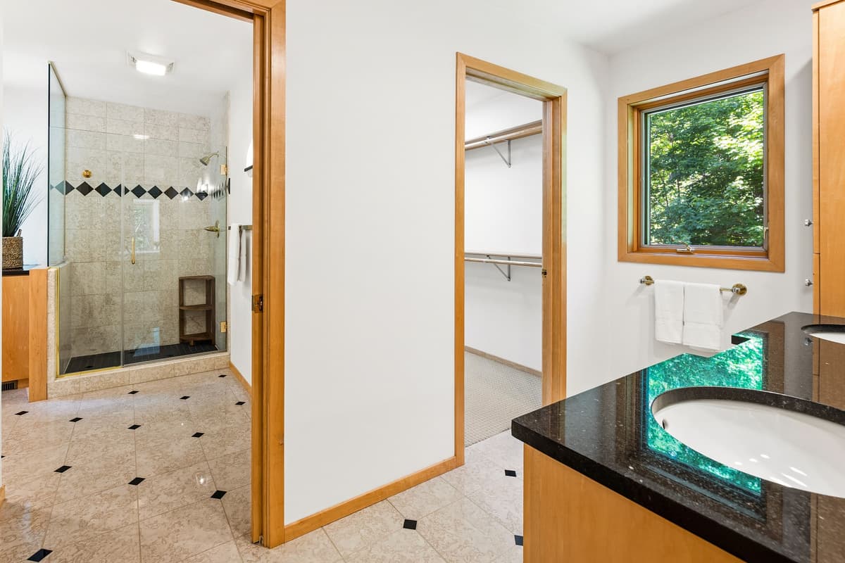 A walk-in closet provides plenty of room to organize clothing, luggage, and personal belongings.