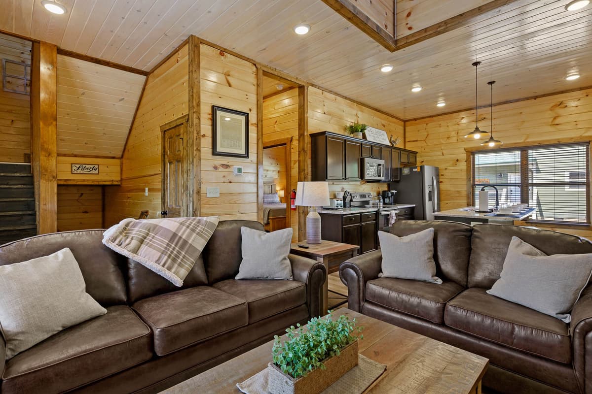 Gather, relax, and make memories in the cabin’s inviting open-concept living, dining, and kitchen area.