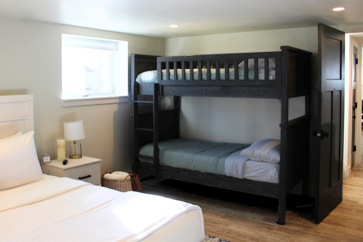 This spacious bedroom features a comfortable king-size bed along with two twin-over-twin bunk beds, making it a great option for families and groups.