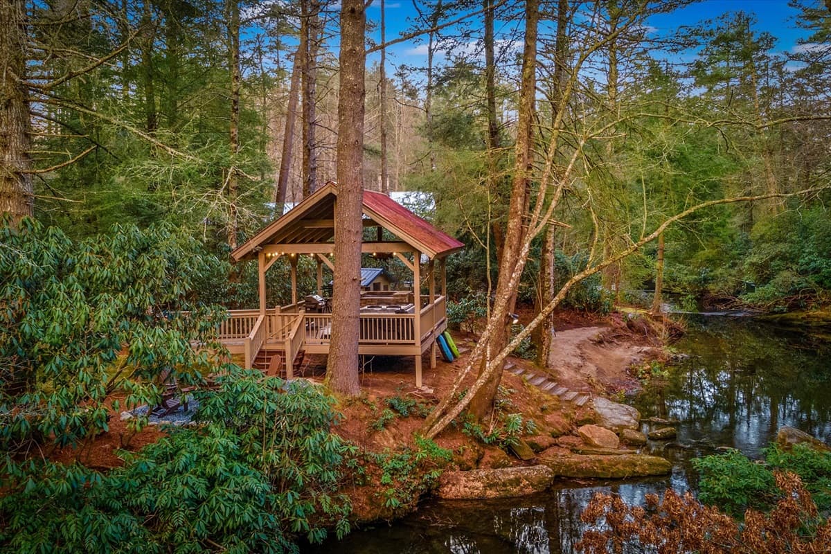 Magical Gazebo Reflected in the Still River Water Surrounded by Pine Trees