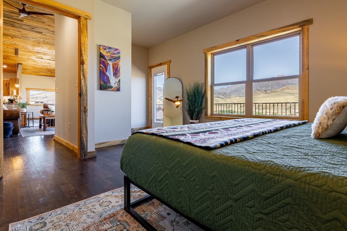 The plush king bed offers the perfect place to recharge after a day of exploring Cody, Wyoming. Enjoy a peaceful atmosphere where you can unwind and settle in for a restful night.