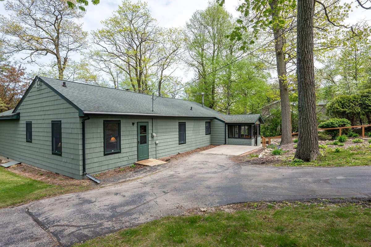 The mature trees and greenery add to the home’s welcoming atmosphere.