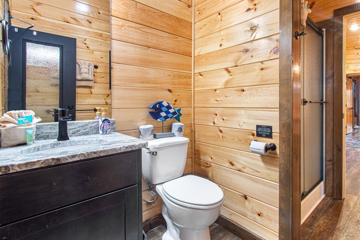 Conveniently located just off the pool room, this main-level bathroom makes it easy to freshen up without having to head back into the cabin.