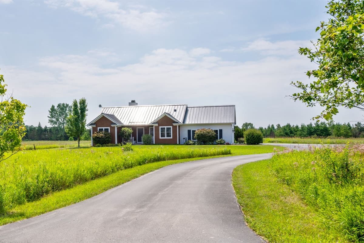 Driveway leading up to the Baileys Harbor home, offering a warm welcome and plenty of space for easy parking.