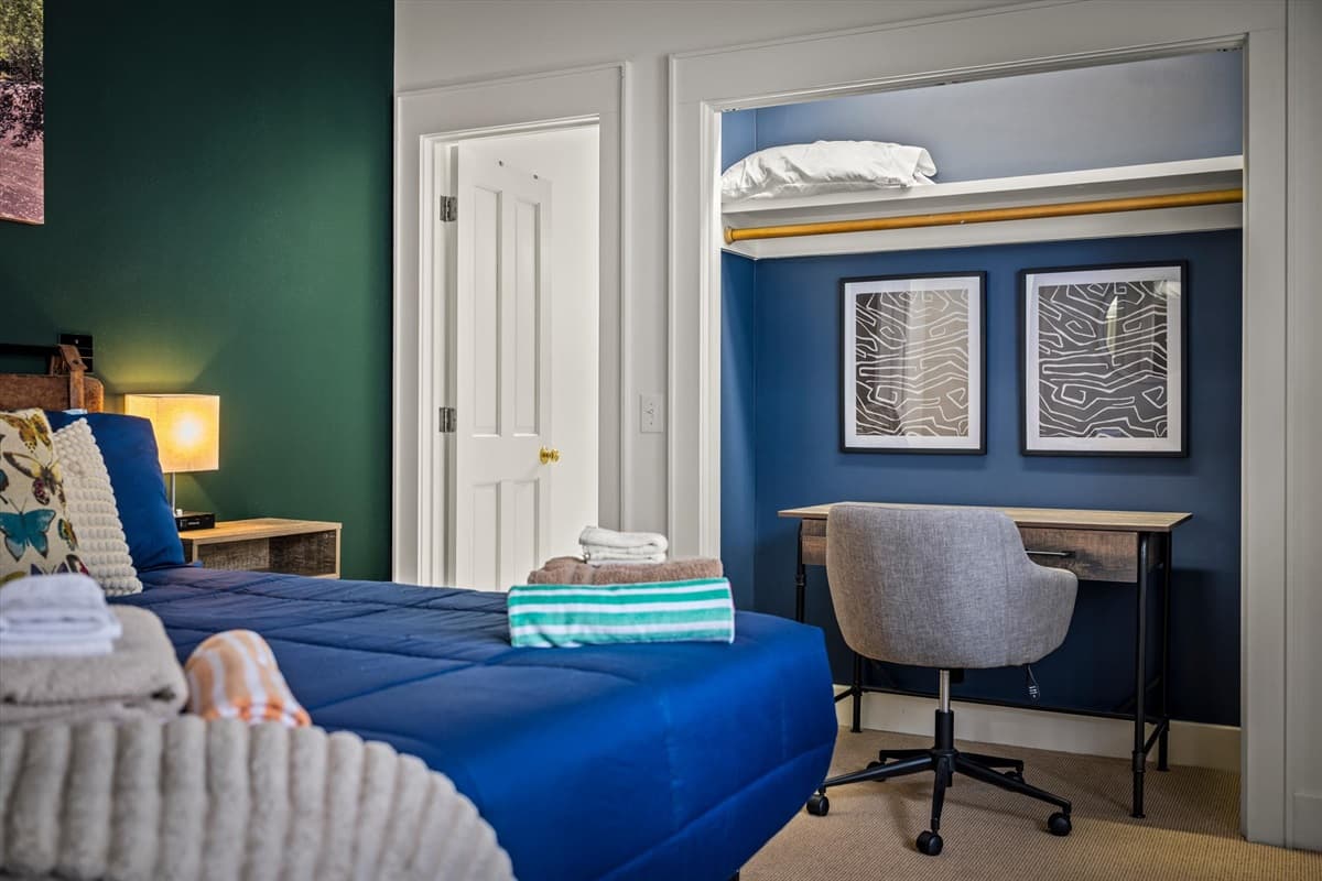 Dedicated Workspace in the Third Bedroom with Wood Desk and Chair