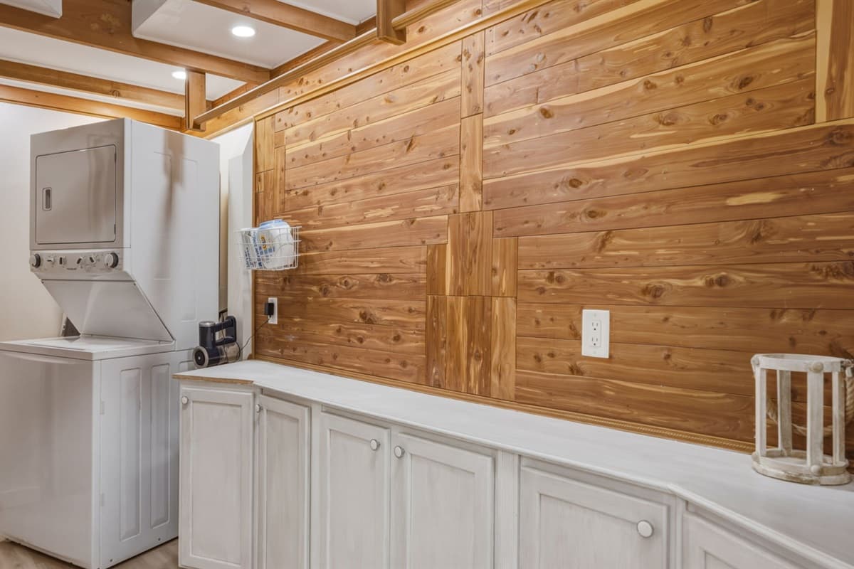 Convenient laundry room equipped with a washer and dryer, making it easy for guests to freshen up clothes during their stay. A practical space designed for longer visits, outdoor adventures, or keeping up with family travel