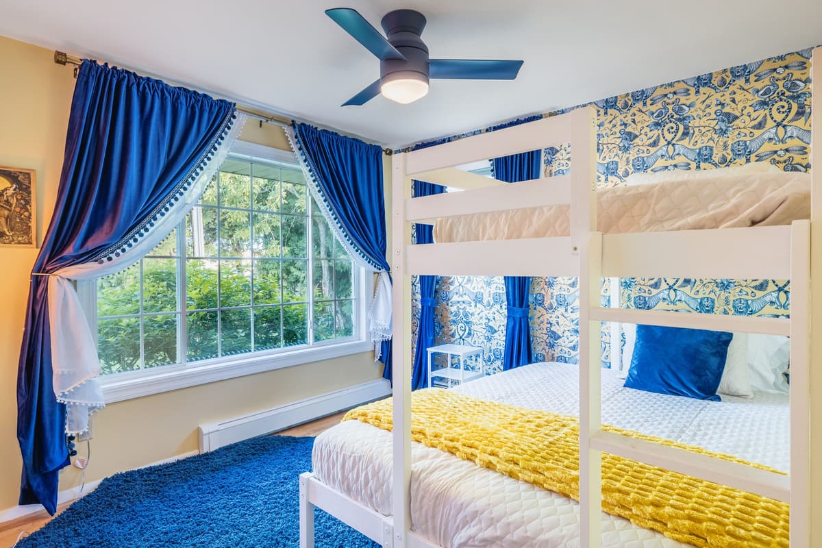 The queen bed provides a spacious place to rest, while the twin bunk is perfect for a child or additional guest. The setup makes this room a great choice for families or groups traveling together.