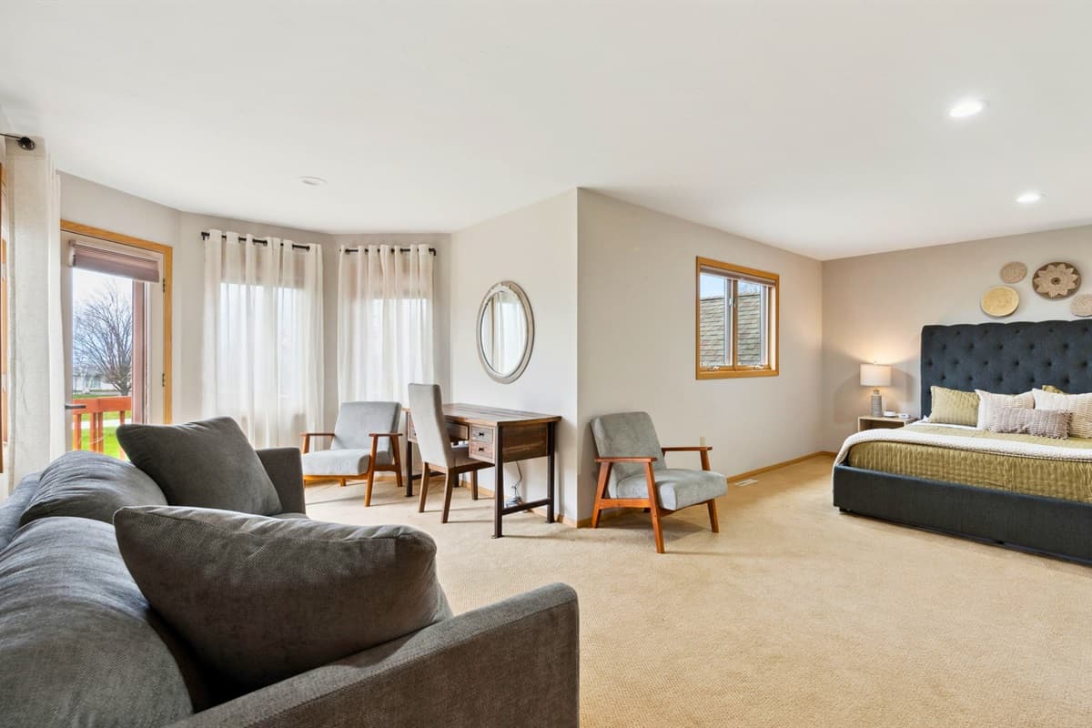 Bright and airy bedroom featuring a cozy bed, fresh linens, and plenty of natural light.
