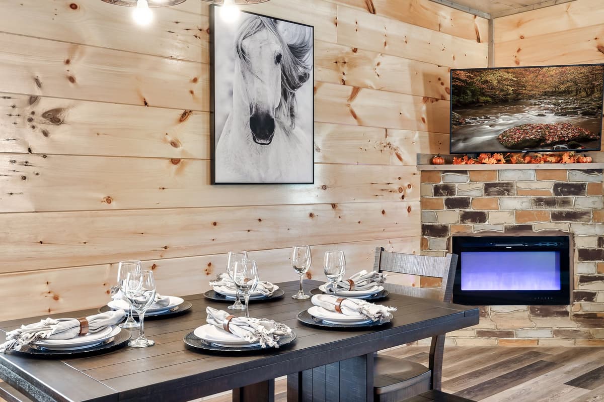 Gather around the table for a meal, then settle into the cozy living room with the fireplace glowing nearby.