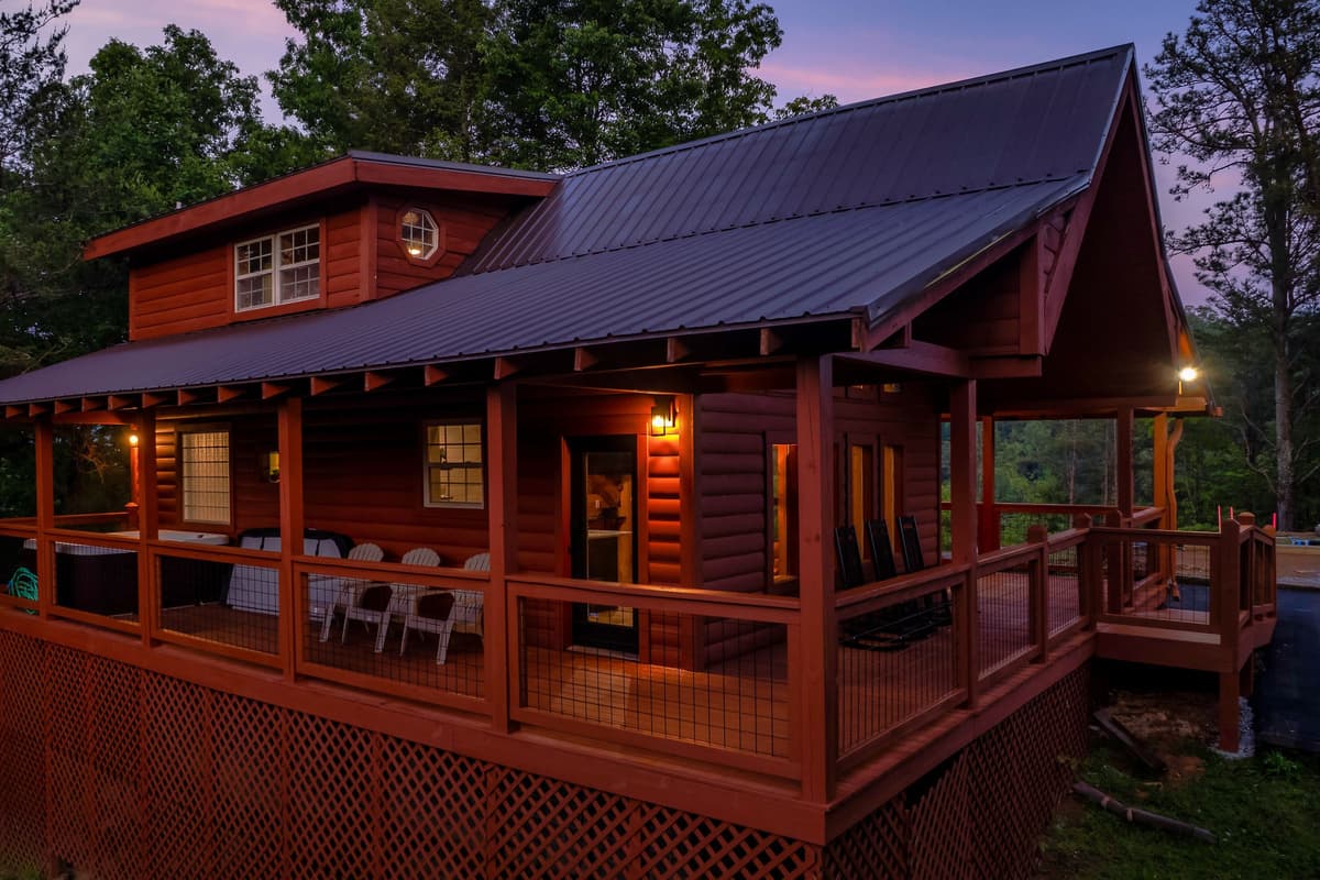 The soft twilight sky and warm glow of the cabin create the perfect setting for a peaceful evening.