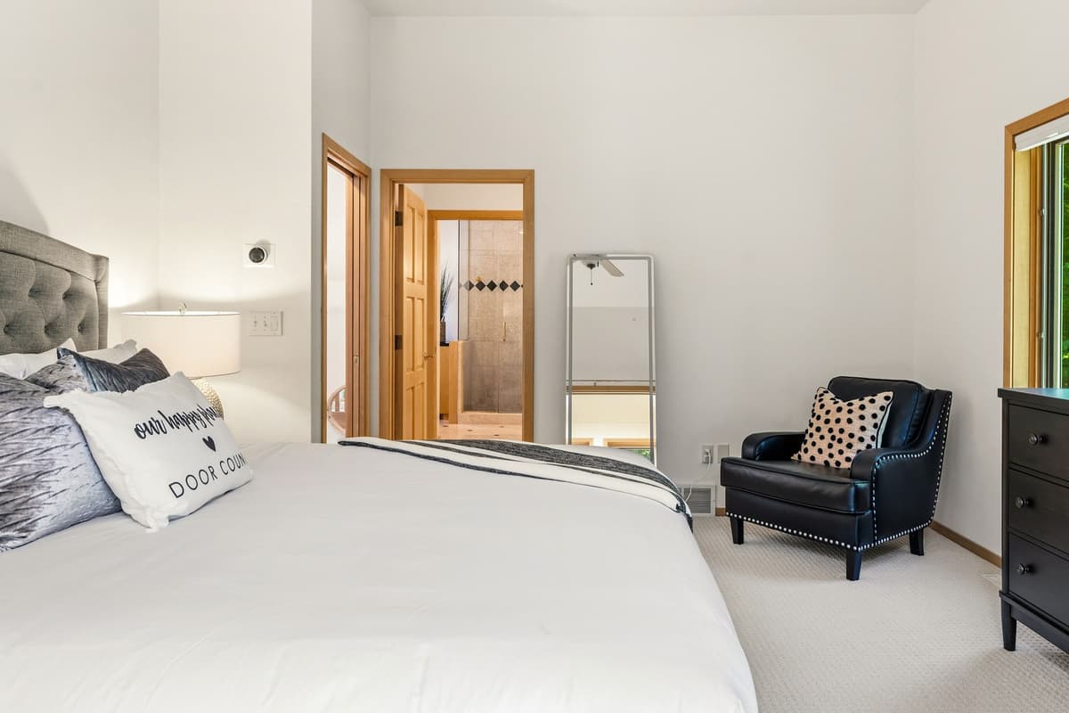 The upper-level king bedroom offers a comfortable and inviting retreat for a restful stay.
