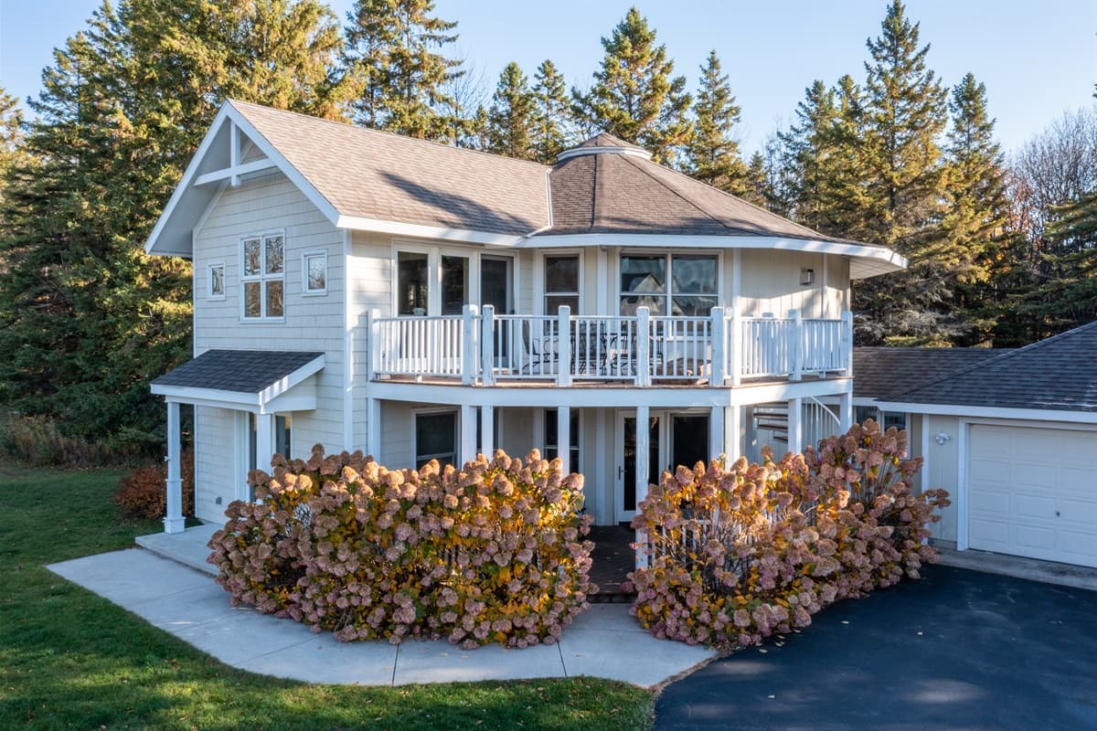 Cozy home nestled in vibrant fall foliage and autumn colors.